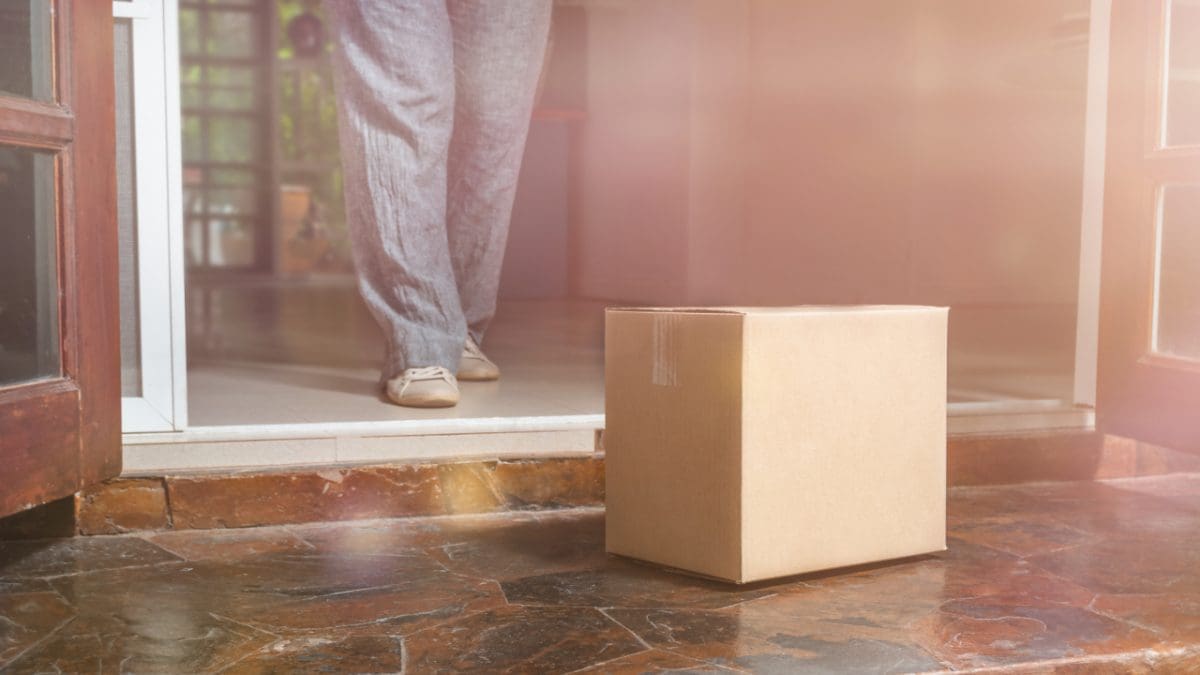 Photo of package delivery at customer's house threshold