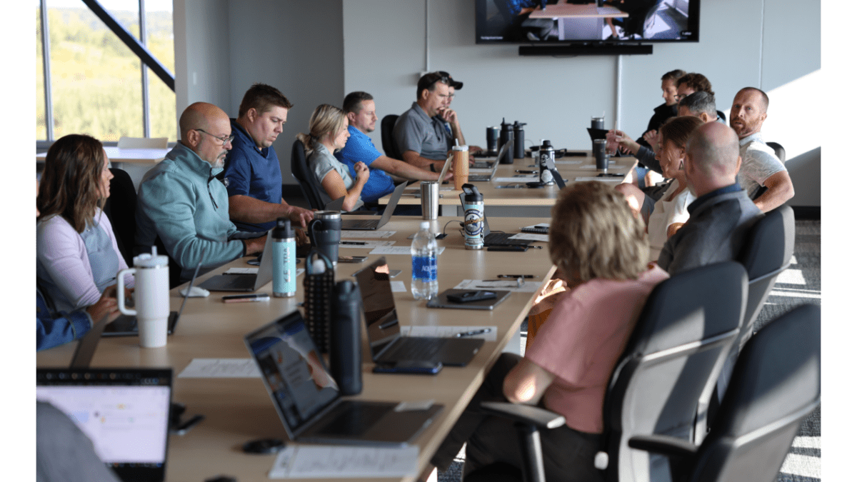 Image of the Elite EXTRA team meeting in a conference room during the 2023 company event